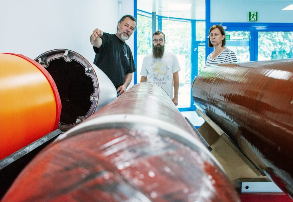 AGH staff examining SF-100 thrusters during a meeting at SpaceForest headquarters.