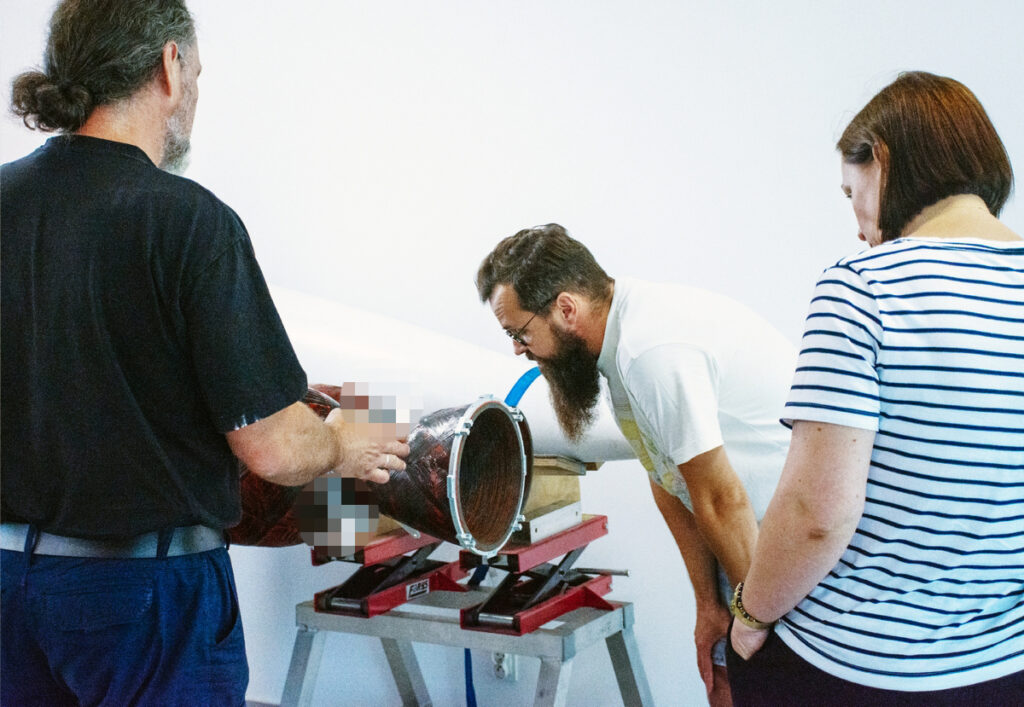 AGH researchers and SpaceForest engineers reviewing a CFRC engine nozzle on the SF-1000 rocket engine.