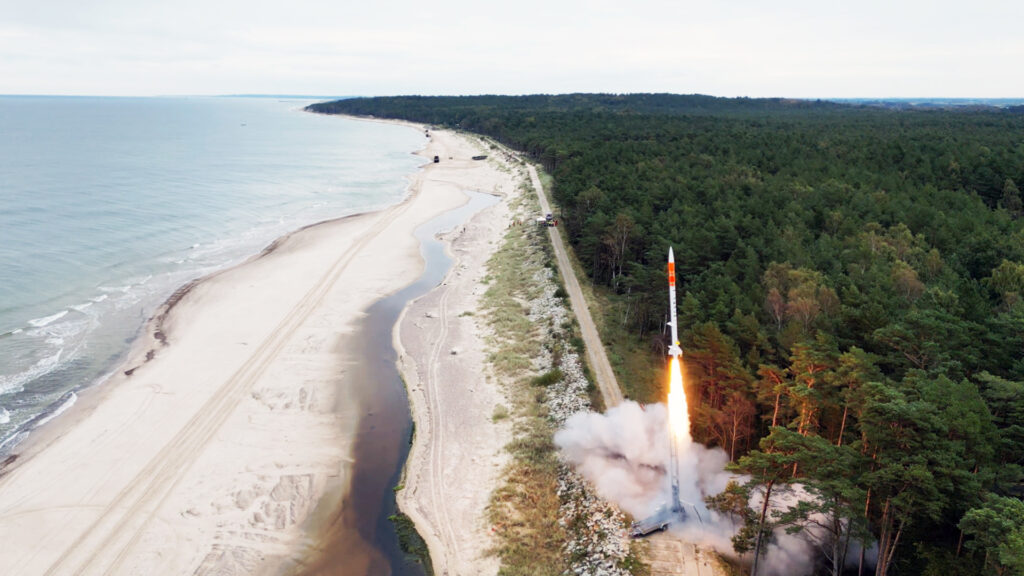 Perun rocket by SpaceForest launching into the sky, surrounded by plumes of smoke and fire