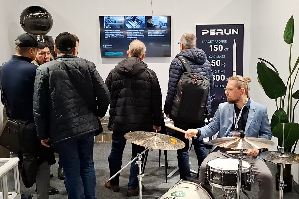 Guests exploring composite structures and the Polmuz percussion set at SpaceForest’s booth at Composite Poland 2025.